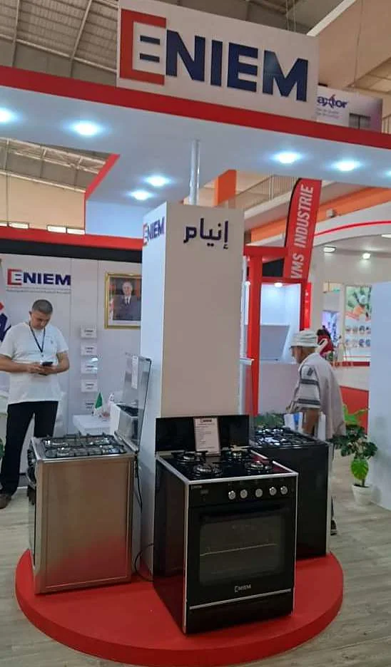 Stand ENIEM rouge et blanc, cuisinière présentée sur un podium circulaire